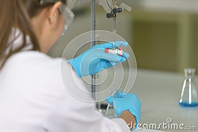 The woman whoâ€™s the scientist is demonstrate the titration technique Stock Photo